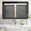 A kitchen sink area with a faucet, soap dispensers, and a vase of flowers, with dark gray sheer curtains hanging in the window above. Produktbild-Vorschau