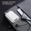 A white USB charger, a smartphone, and earphones are placed on a gray fabric surface, suggesting a travel or portable tech setup. Produktbild-Vorschau