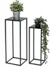 Two black metal plant stands of different heights, each holding a potted plant, against a white background. Produktbild-Vorschau
