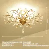 A close-up view of a gold-colored crystal chandelier with dimensions indicated. Produktbild-Vorschau