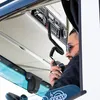 A man in sunglasses is inside a truck cabin, holding and speaking into a radio. Anteprima dell’immagine prodotto