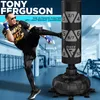 A man is kicking a punching bag in a gym. Produktbild-Vorschau