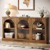 A wooden console table with arched compartments, decorated with books, a vase, and decorative items. Voir les images du produit