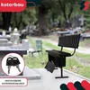 A black metal bench with a storage box underneath, placed in a cemetery setting. Produktbild-Vorschau