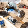 A person is using a Scheppach wet/dry grinder to sharpen a tool, with tools and batteries in the background. Produktbild-Vorschau