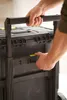 A person's hands are shown interacting with a black modular toolbox on wheels. Voir les images du produit