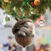 A cute bunny sleeping in an acorn ornament hanging from a Christmas tree. Produktbild-Vorschau