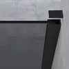 Close-up of a black framed shower wall with a concrete wall in the background. Anteprima dell’immagine prodotto