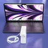 A laptop charger and cable are placed in front of a laptop. Podgląd zdjęcia produktu
