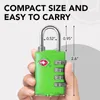 A hand holding a green TSA-approved combination lock with dimensions indicated. Produktbild-Vorschau