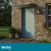 A door with an awning above it, set in a stone wall. Náhled obrázku produktu