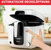 A hand is pressing a button on a white and black deep fryer, with the lid open, in a kitchen setting. Produktbild-Vorschau