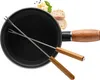 A fondue pot with two fondue forks, along with some bread, cheese, and herbs. Produktbild-Vorschau
