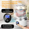 A close-up of a portable mini washing machine with clothes inside, with a finger pressing a button. Produktbild-Vorschau