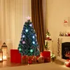 A decorated Christmas tree in a living room setting with gifts and a fireplace. Voir les images du produit