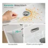 A collage of images showcasing a ceramic washbasin, highlighting its ease of cleaning, standard depth, and efficient drainage. Anteprima dell’immagine prodotto