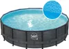 An above-ground swimming pool with a rattan-style frame, filled with blue water. A close-up inset shows the tiled pattern of the pool liner. Produktbild-Vorschau