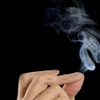 A close-up of a hand creating smoke from its fingers, against a black background. Náhled obrázku produktu