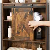 A hand is opening a sliding barn door on a wooden bathroom shelf unit, revealing rolled towels inside. Produktbild-Vorschau