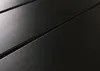 A close-up, angled view of a dark, textured surface with parallel grooves. Produktbild-Vorschau