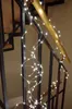 A string of LED lights is draped along a staircase railing. Produktbild-Vorschau