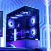 A gaming PC with RGB lighting is displayed in a room with blue geometric lighting. Produktbild-Vorschau