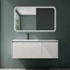 A modern bathroom vanity with a sink and faucet, set against a teal wall. Produktbild-Vorschau