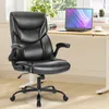 A black office chair is shown in a home office setting with a desk and laptop in the background. Voir les images du produit