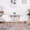 A modern dining set with two white chairs and a black round table in a well-lit room. Voir les images du produit