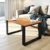 A modern living room scene with a coffee table in the foreground and a sofa in the background. Náhled obrázku produktu