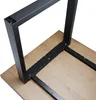 A black metal table frame is being attached to a wooden tabletop with screws. Anteprima dell’immagine prodotto