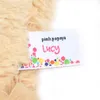 A close-up of a label attached to a plush toy. Podgląd zdjęcia produktu