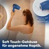 A woman is drying her hair in a bathroom with a hairdryer. Anteprima dell’immagine prodotto
