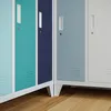 Close-up view of the lower doors and legs of multiple metal lockers. Anteprima dell’immagine prodotto