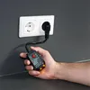 A hand holds a circuit finder and voltage tester plugged into a wall socket. Náhľad obrázku produktu