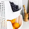 Two stacked white storage containers, one filled with blueberries and the other with oranges. A wooden mortar and pestle is visible in the background. Anteprima dell’immagine prodotto