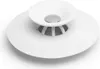A white silicone bathtub stopper and hair catcher with a metallic accent in the center, shown from a slightly elevated angle on a white background. Voir les images du produit
