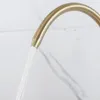A close-up shot of a gold faucet with water flowing out. Podgląd zdjęcia produktu