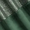 A close-up view of a dark green curtain with a patterned section. Produktbild-Vorschau