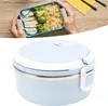 Hands holding a lunchbox filled with food, with a second lunchbox shown below. Produktbild-Vorschau