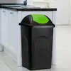 A black trash can with a green lid is placed in a kitchen setting next to white cabinets. Produktbild-Vorschau
