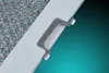 A close-up of a metallic filter and its white frame with a clip. Produktbild-Vorschau