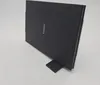 A black Canon flatbed scanner is shown standing upright on a white surface, supported by a small black stand. Produktbild-Vorschau