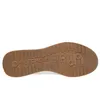 The sole of a white sneaker with a brown rubber sole. Produktbild-Vorschau