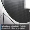 A close-up of a round mirror's edge, showing the polished finish and the tiled background. Anteprima dell’immagine prodotto