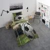 A bedroom scene with a bed featuring football-themed bedding, a chair, and a bookshelf. Produktbild-Vorschau