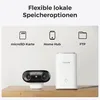 A camera and a hub are shown on a wooden surface, with icons and text above them illustrating storage options. Produktbild-Vorschau