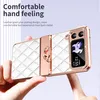 A hand holding a white flip phone case with rose gold accents and rhinestones. Produktbild-Vorschau