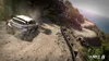 A rally car driving on a winding dirt road next to the ocean. Produktbild-Vorschau