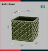 A green ceramic planter with dimensions indicated by measurement lines and text. Produktbild-Vorschau
